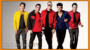 Five men in colorful jackets posing together for a promotional photo, with a "hollywood.tv" watermark at the bottom.