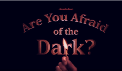 A hand holding a lit match, with the text "are you afraid of the dark?" and the nickelodeon logo above, all against a dark background.