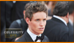 A man in a black tuxedo and bow tie at a formal event, looking to the side with a thoughtful expression. a "celebrity gps" watermark is visible.